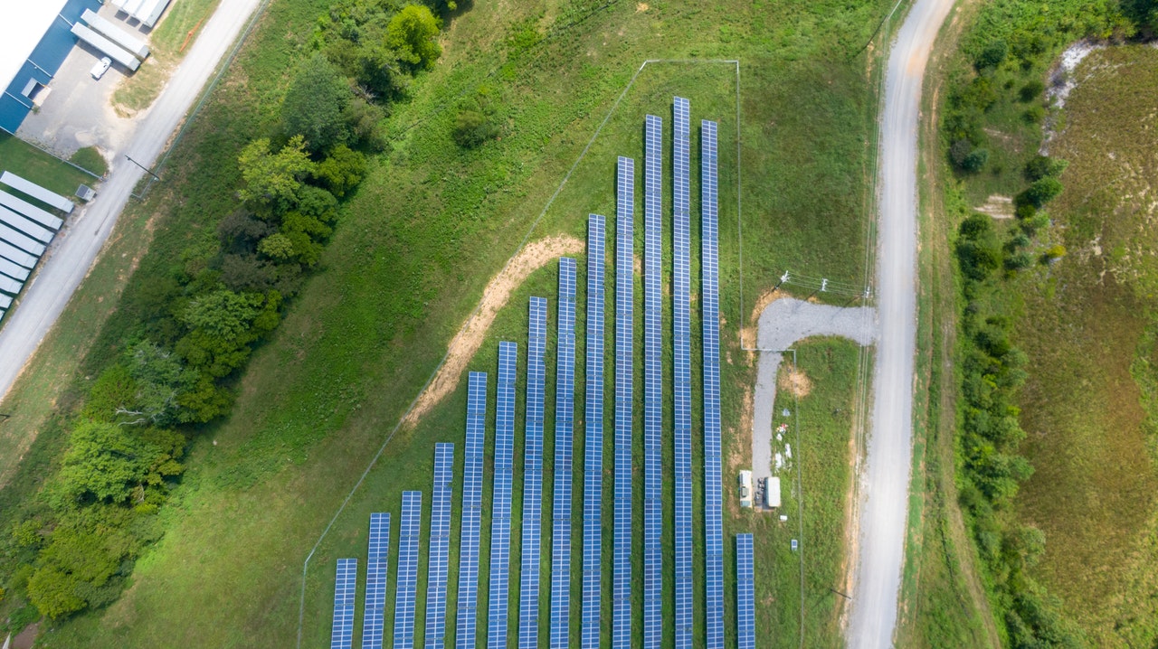 Free Aerial View of Solar Panels Array on Green Grass