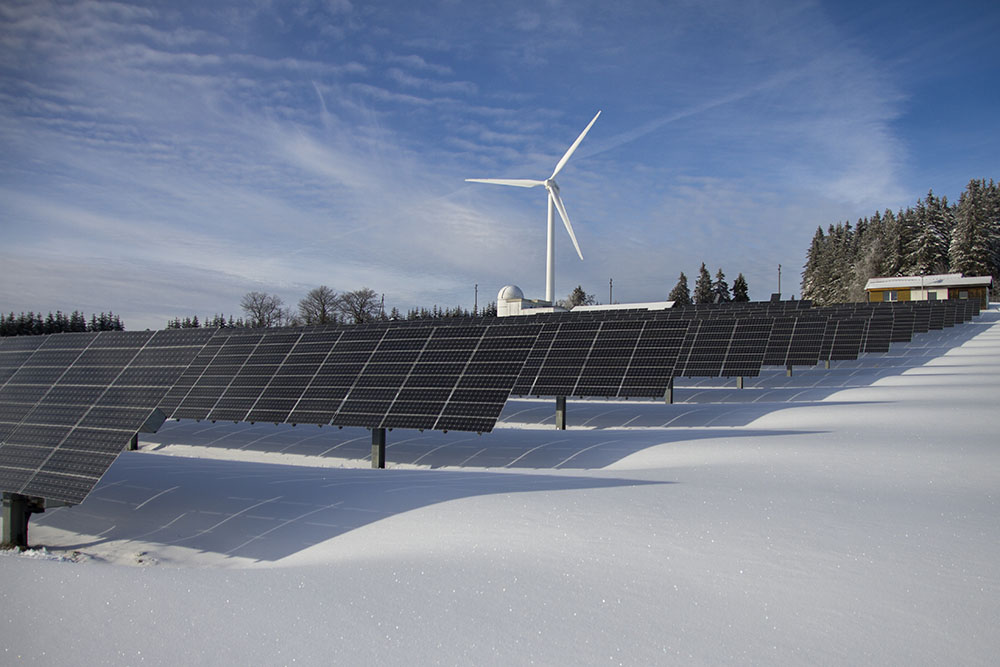Free Solar Panels on Snow With Windmill Under Clear Day Sky